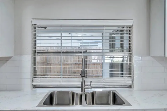 a kitchen with a sink and a window