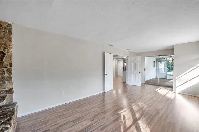 a view of empty room with wooden floor