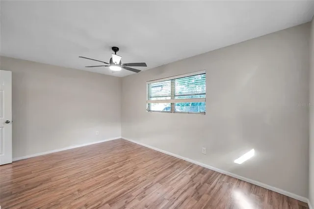 wooden floor in an empty room with a window