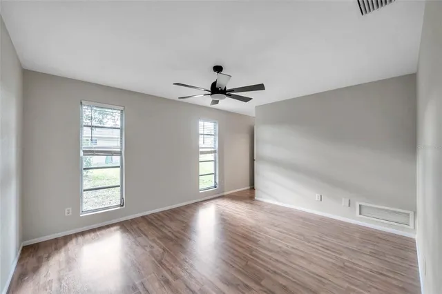 wooden floor in an empty room with a window