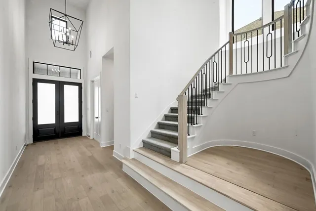 a view of staircase with white walls and windows