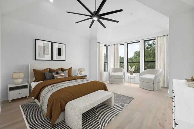 a bedroom with a bed and a large window