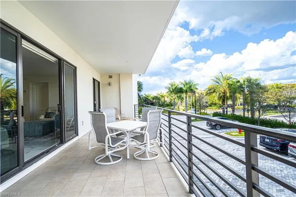 a kitchen with stainless steel appliances a table and chairs in it