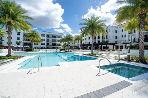 a swimming pool with outdoor seating and yard