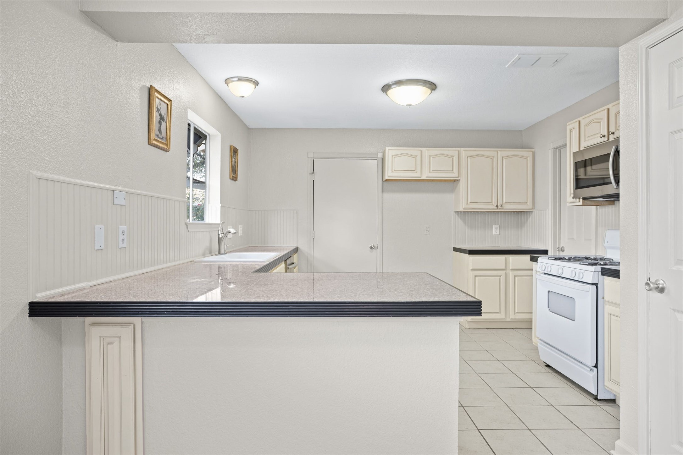 2408 West Messick Loop Round Rock, TX 78681 - Photo 12 of 28 Upper cabinets have been rehung along the left kitchen wall.