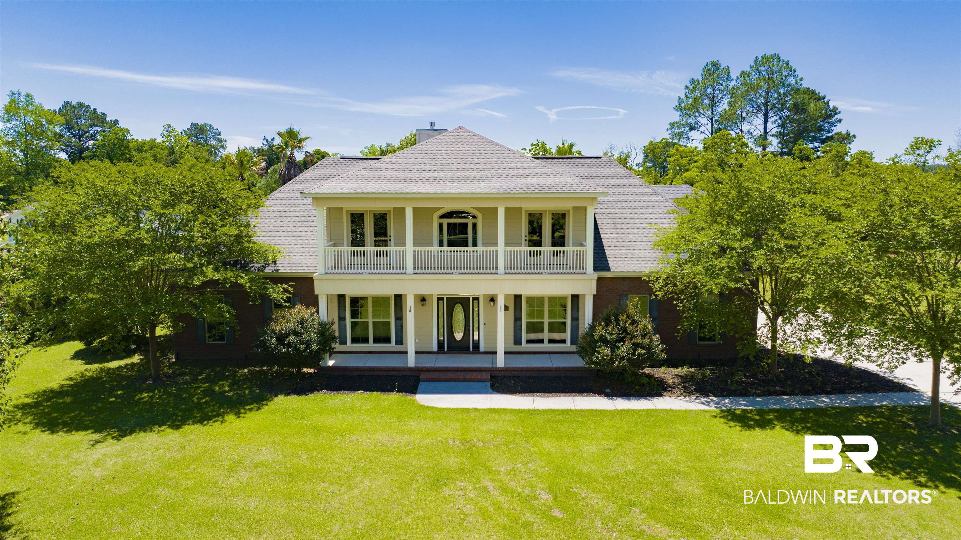 12944 Anna's Way Stapleton, AL 36578 - Photo 1 of 64 Traditional brick and stucco residence featuring a two-story design with a prominent front porch and upper balcony