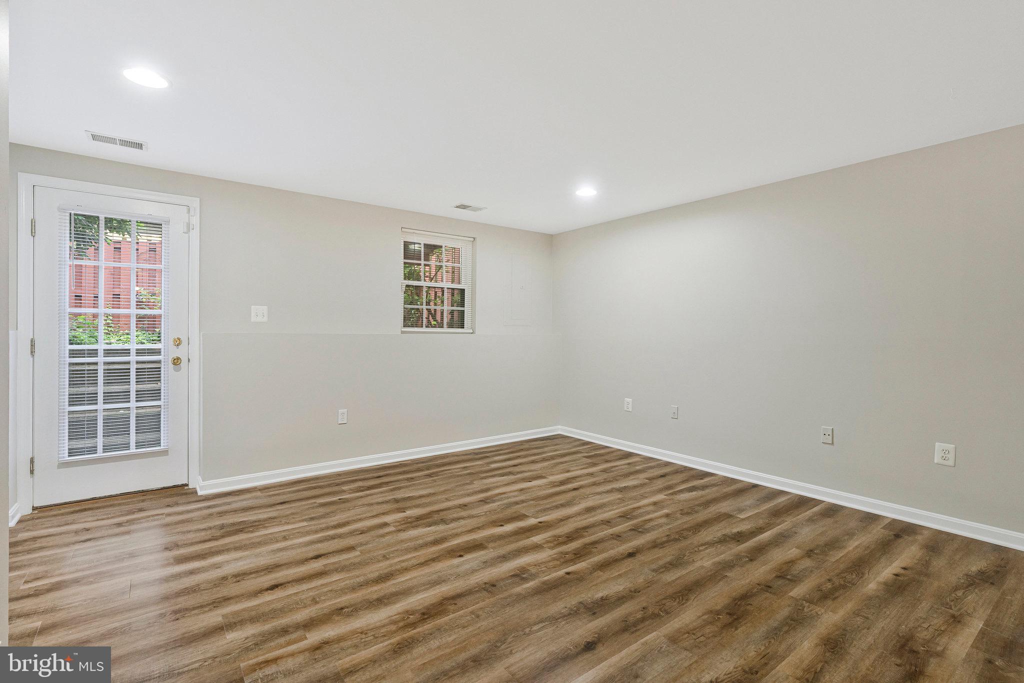 22011 Box Car Square Sterling, VA 20166 - Photo 15 of 19 a view of an empty room with wooden floor and a window