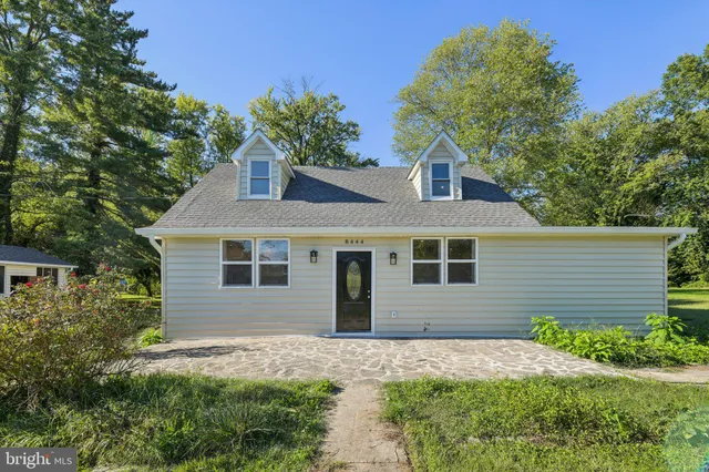 a front view of house with yard and trees