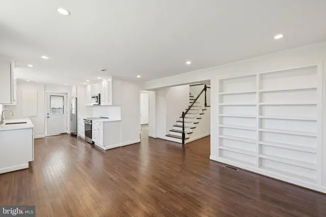 a view of a kitchen with wooden floor and a sink
