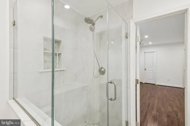 a bathroom with a shower and a glass door