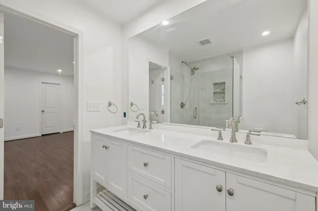 a bathroom with double sink and a mirror