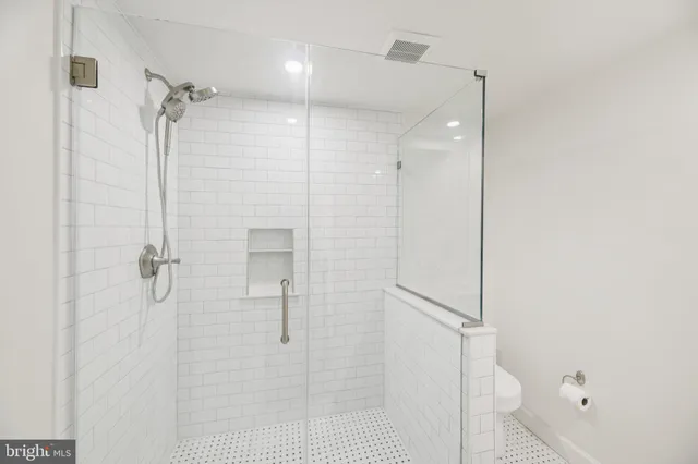 a bathroom with a shower and a glass door