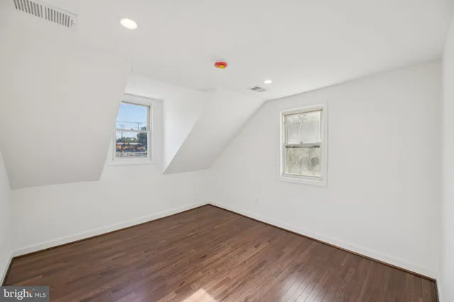 a view of a room with wooden floor and white walls