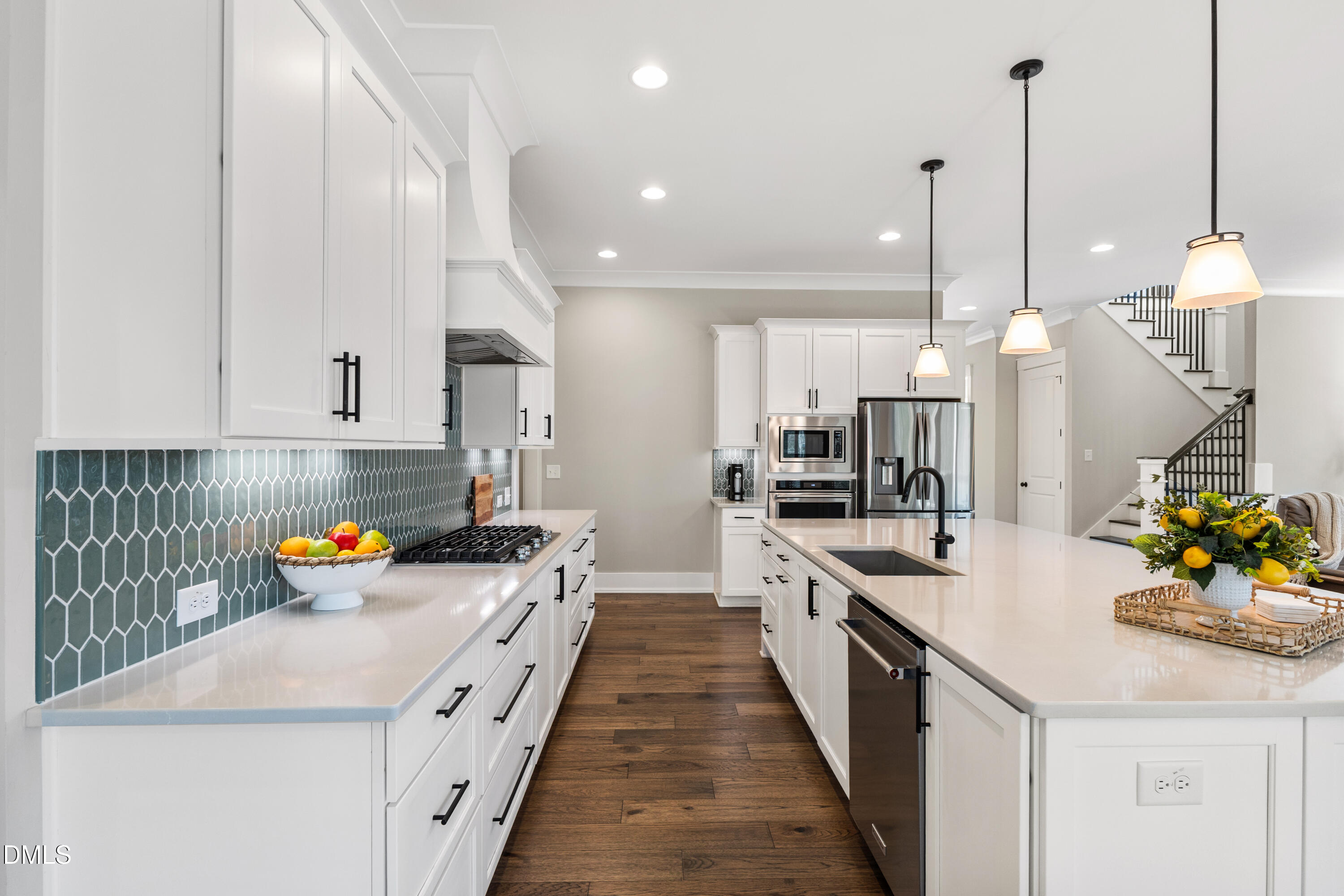 75 Cottage Way Pittsboro, NC 27312 - Photo 5 of 68 a large kitchen with stainless steel appliances lots of counter space and wooden floor