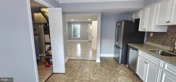 a kitchen with a refrigerator and a stove