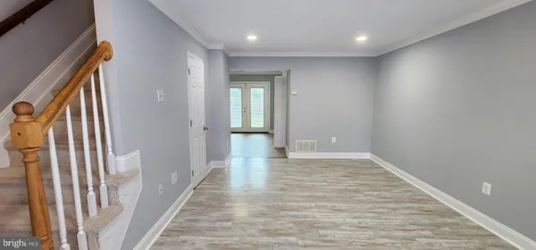 a view of a hallway with wooden floor