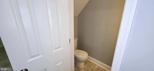 a white toilet sitting next to a shower
