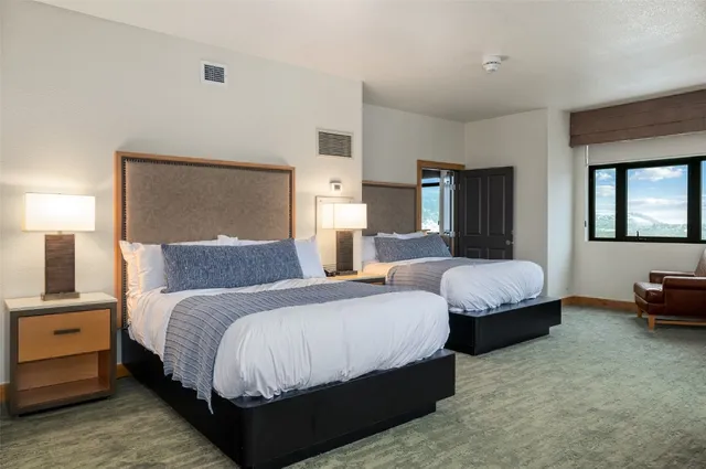 a spacious bedroom with a bed and window