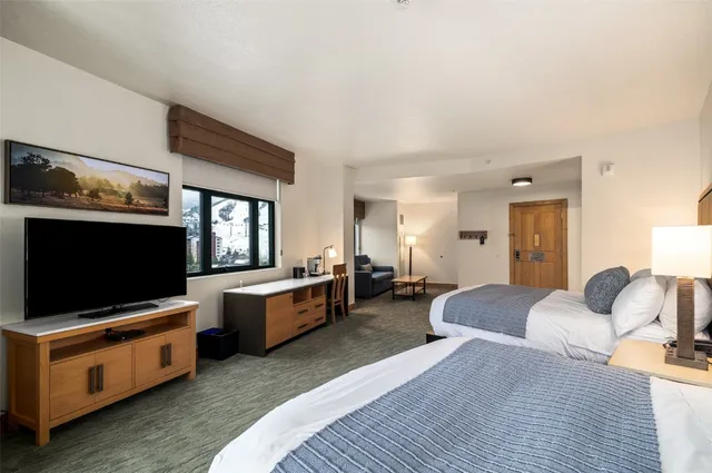 a bedroom with furniture and a flat screen tv