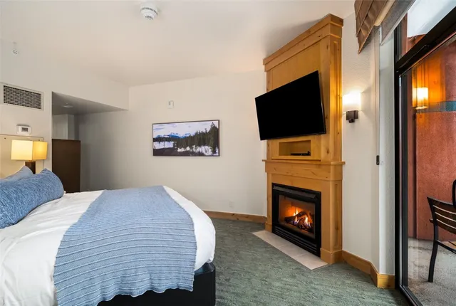 a bedroom with a bed and a television