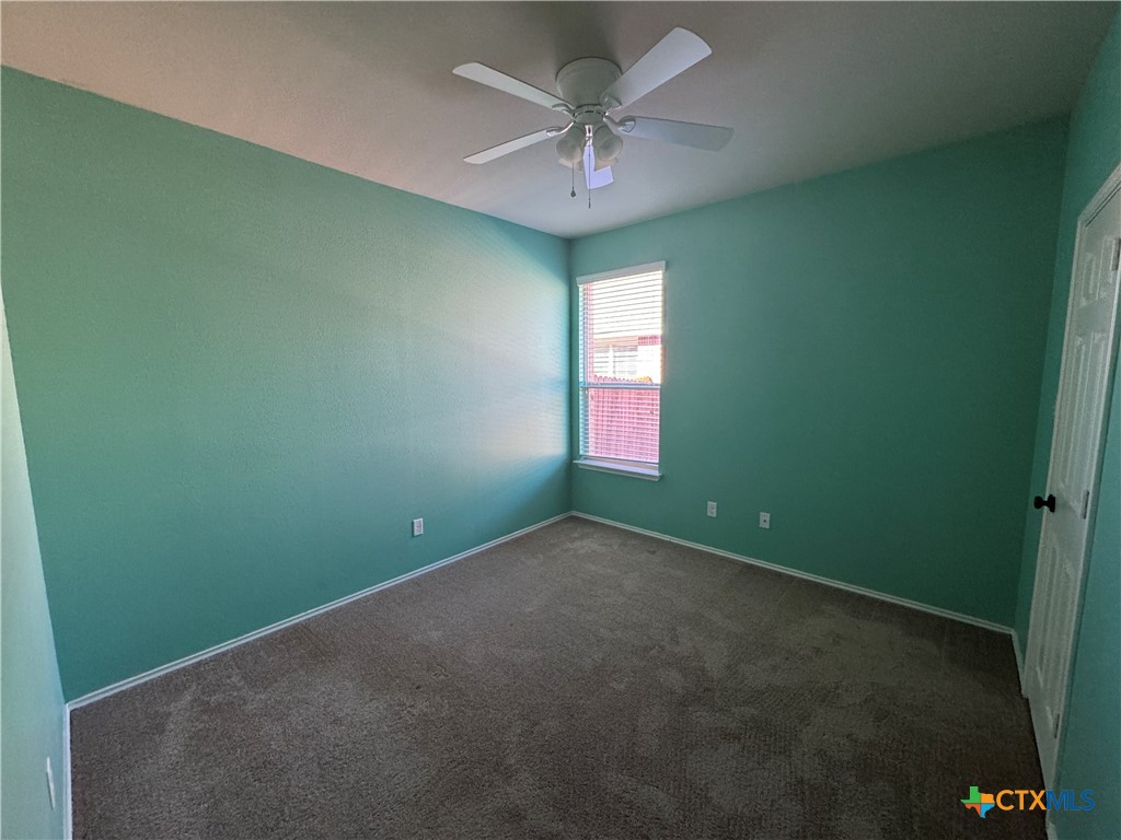 6801 Modesto Road Killeen, TX 76542 - Photo 4 of 26 an empty room with a window and a fan