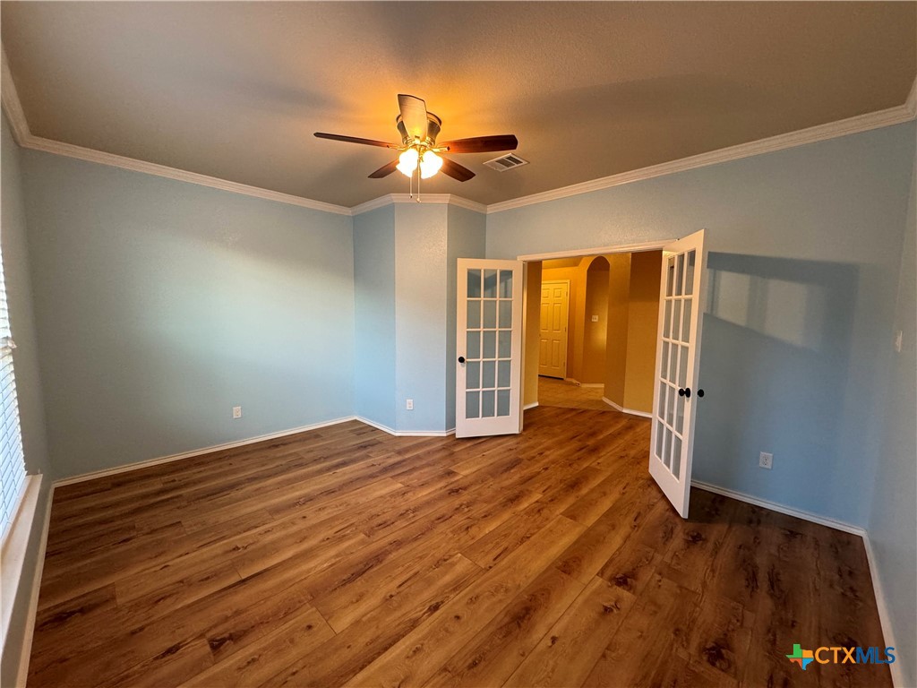 6801 Modesto Road Killeen, TX 76542 - Photo 6 of 26 a view of empty room with wooden floor and fan