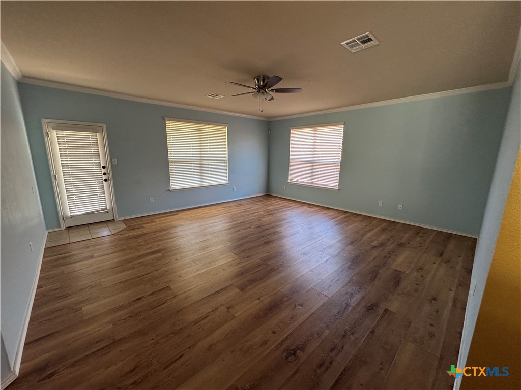 6801 Modesto Road Killeen, TX 76542 - Photo 9 of 26 an empty room with wooden floor and windows