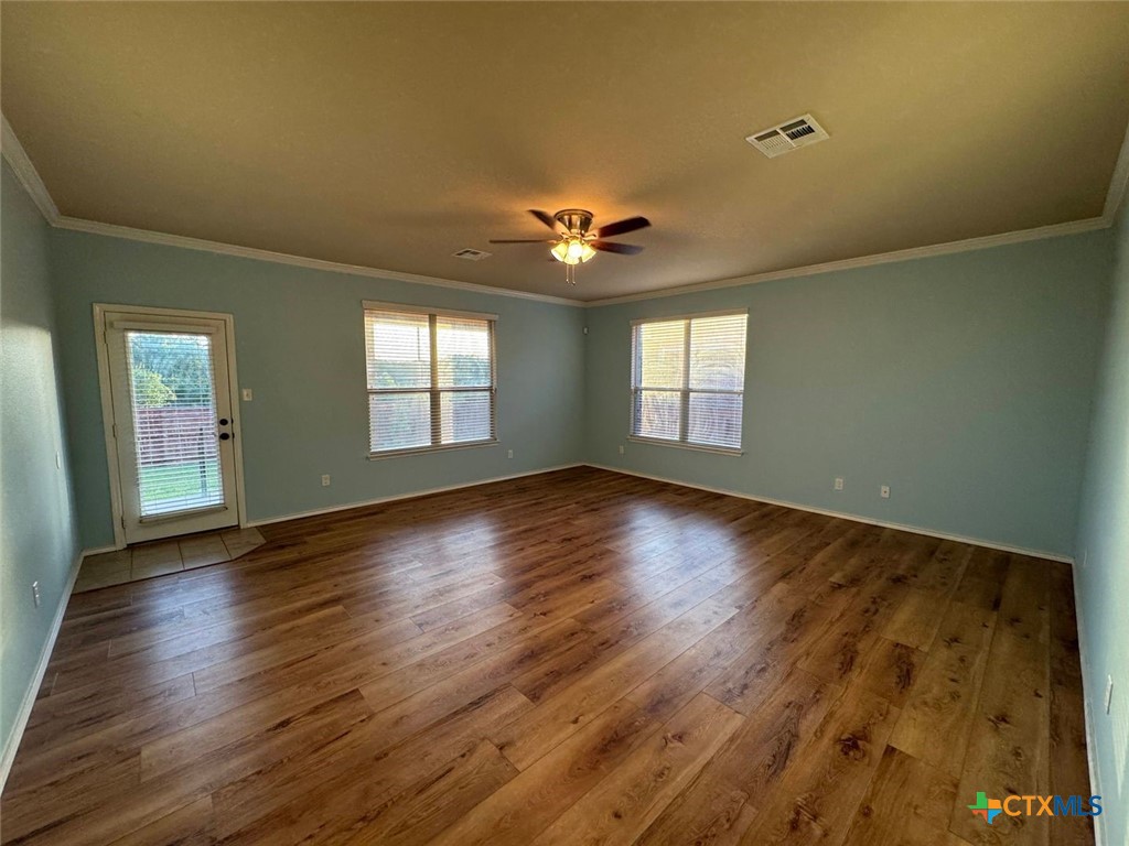6801 Modesto Road Killeen, TX 76542 - Photo 10 of 26 a view of an empty room with window and wooden floor