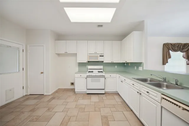 a kitchen with stainless steel appliances granite countertop a sink and cabinets