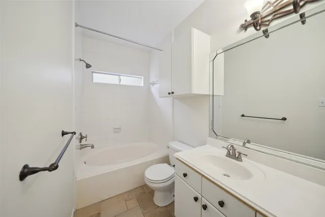 a bathroom with a sink a toilet and a bathtub