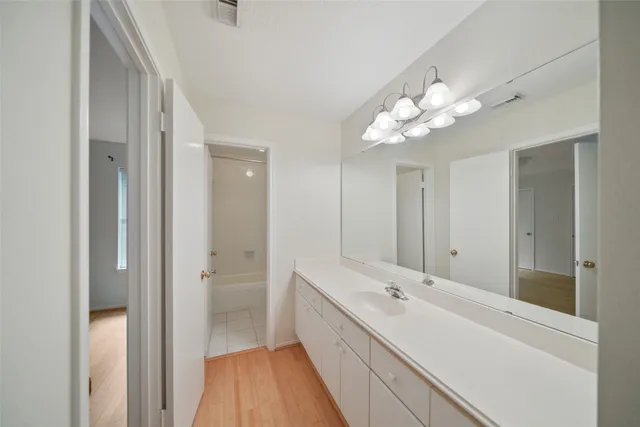 a bathroom with a double vanity sink and a mirror