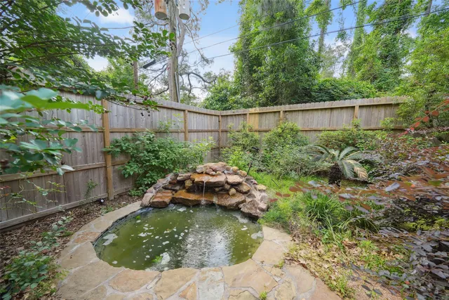 a backyard of a house with a yard and plants