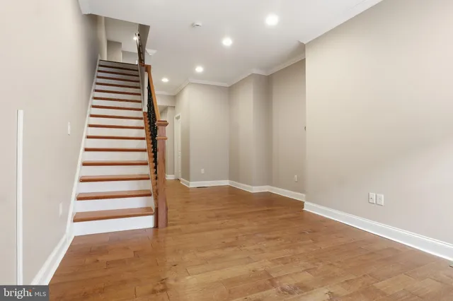 a view of entryway and hall with wooden floor