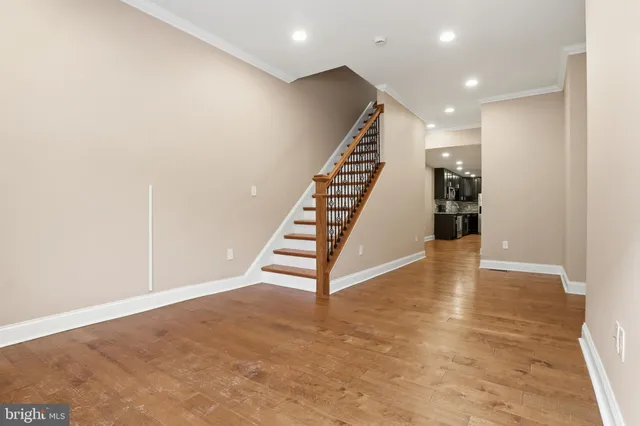 a view of entryway and hall with wooden floor