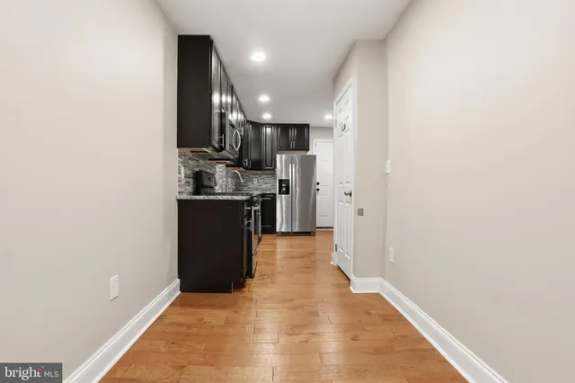a kitchen with stainless steel appliances granite countertop cabinets and refrigerator