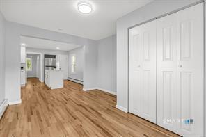 634 Newhall Street Hamden, CT 06517 - Photo 11 of 28 a view of a bedroom with wooden floor and windows