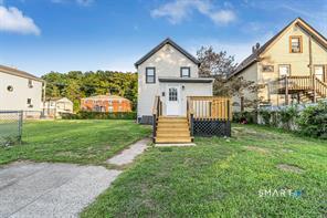 634 Newhall Street Hamden, CT 06517 - Photo 22 of 28 a front view of a house with garden and trees