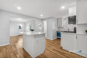 634 Newhall Street Hamden, CT 06517 - Photo 6 of 28 a kitchen with stainless steel appliances granite countertop a sink a stove a microwave a counter space and cabinets
