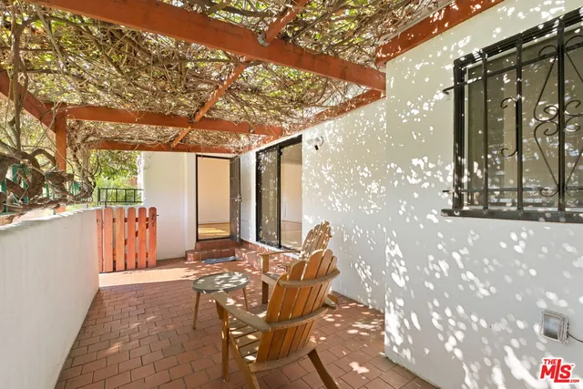 a backyard of a house with table and chairs
