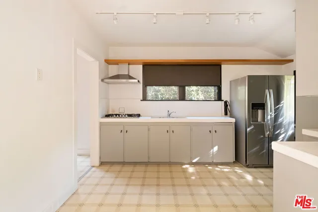 a room with a sink cabinets and utility room