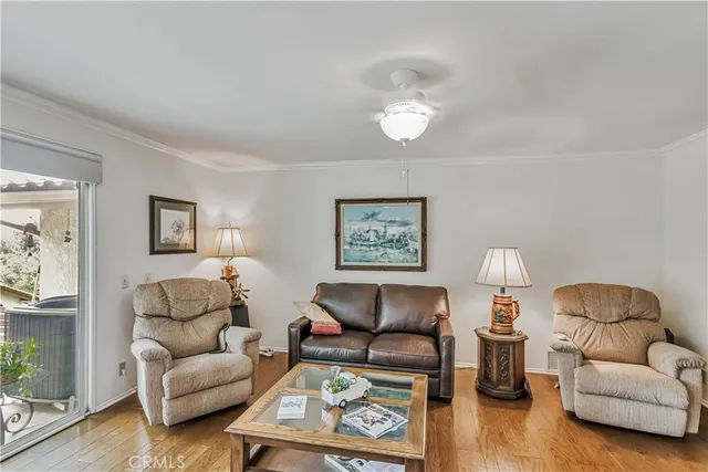 a living room with furniture a couch and wooden floor
