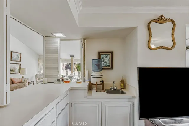 a kitchen with a sink and a stove top oven