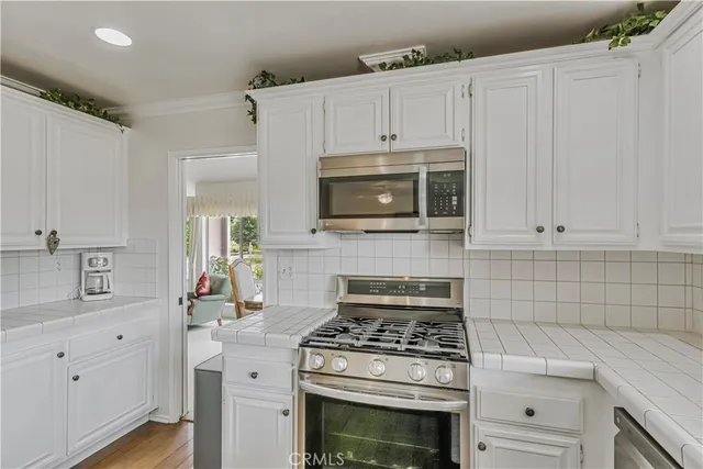a kitchen with cabinets appliances and a sink