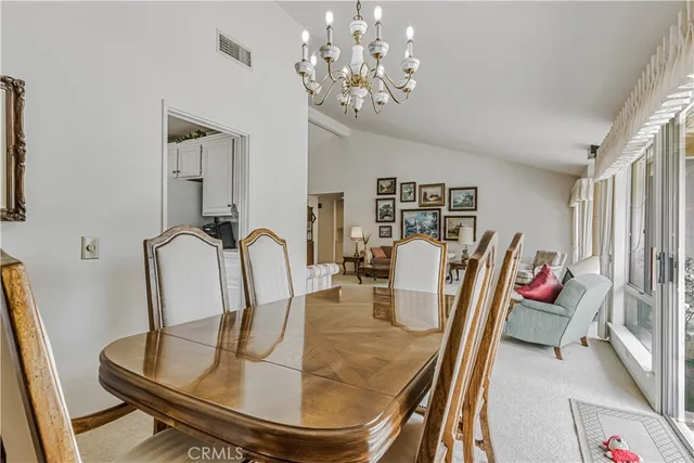 a dining room with furniture a rug and wooden floor