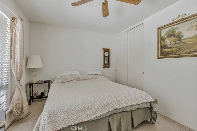 a bedroom with a bed and a painting on the wall