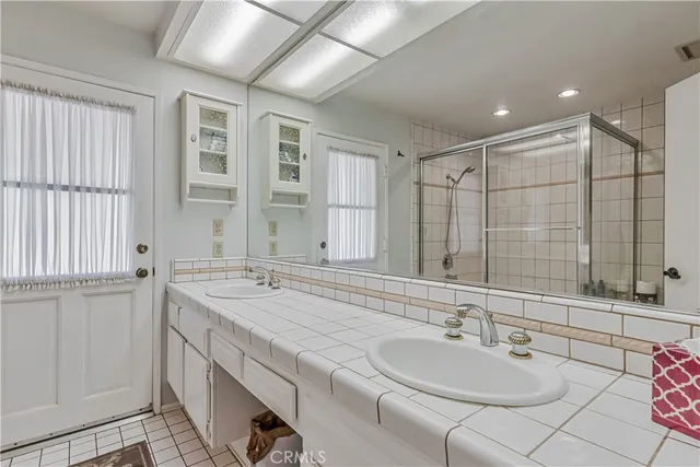a bathroom with double vanity sinks double vanity shower and a bathtub