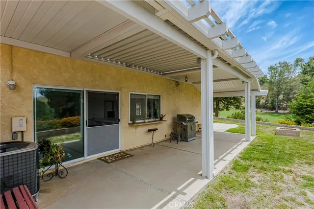 a view of a porch with furniture and a backyard