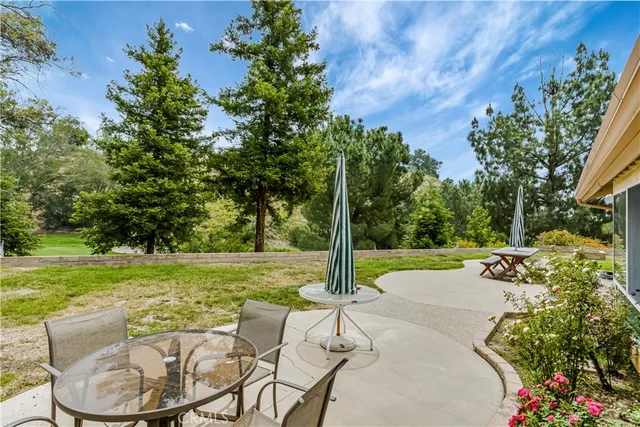 a view of a patio with a table and chairs