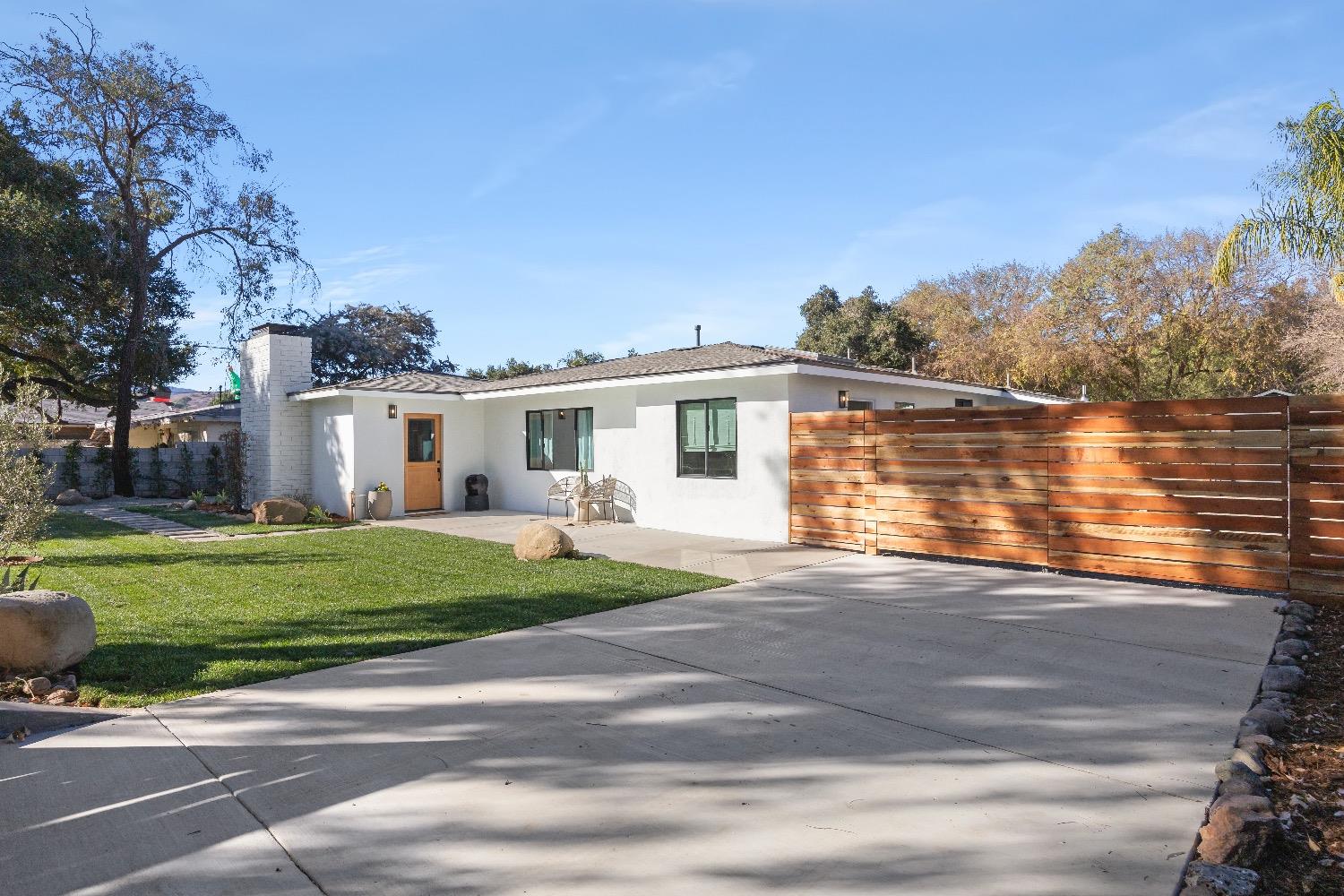 a front view of a house with a yard and balcony