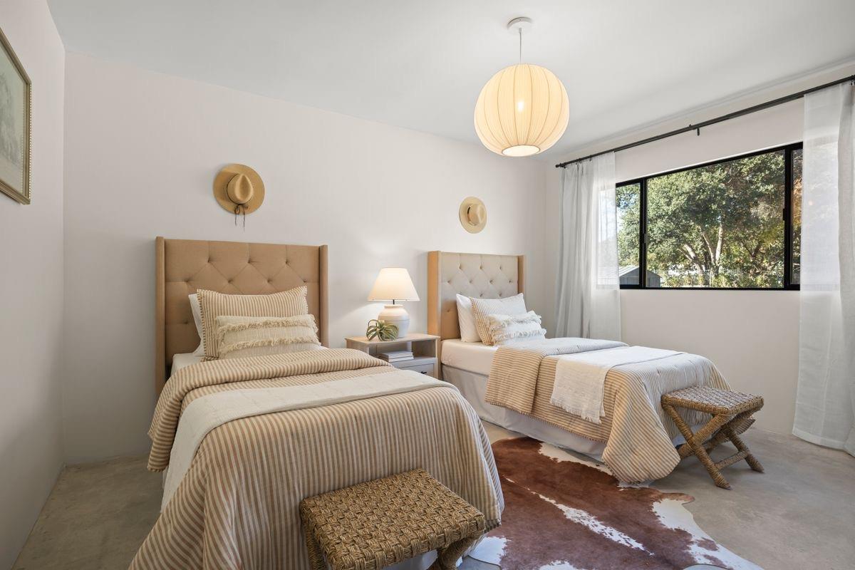 283 Burnham Road Oak View, CA 93022 - Photo 6 of 13 a bedroom with two beds and a chandelier